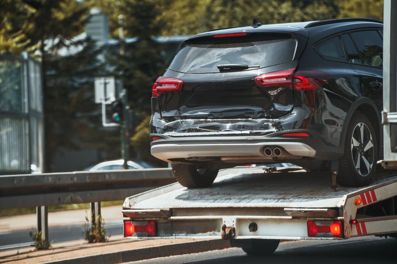 Rear-ended SUV loaded onto a flatbed tow truck