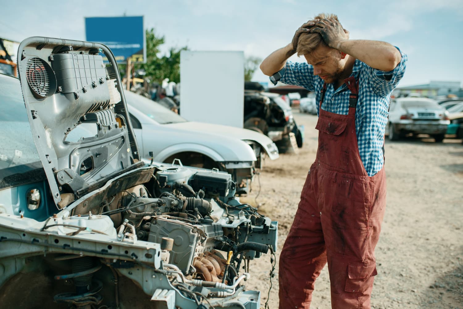 Mechanic assessing an open, non-running engine bay